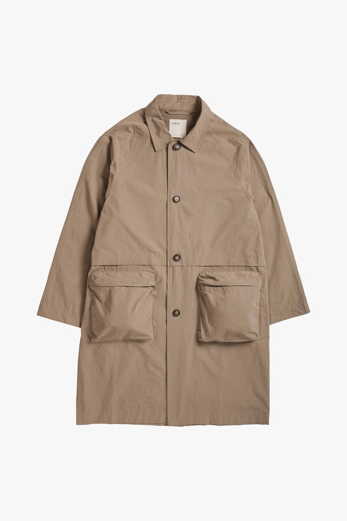 lightweight beige trench coat from satta featuring 4 button front closure and pouch pockets
