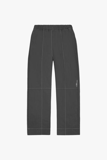front image of contrast stitched charcoal nylon pants from.Afield Out
